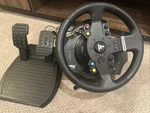 Thrust Master Steering Wheel And Pedals Set. Fixed Price $85.00.